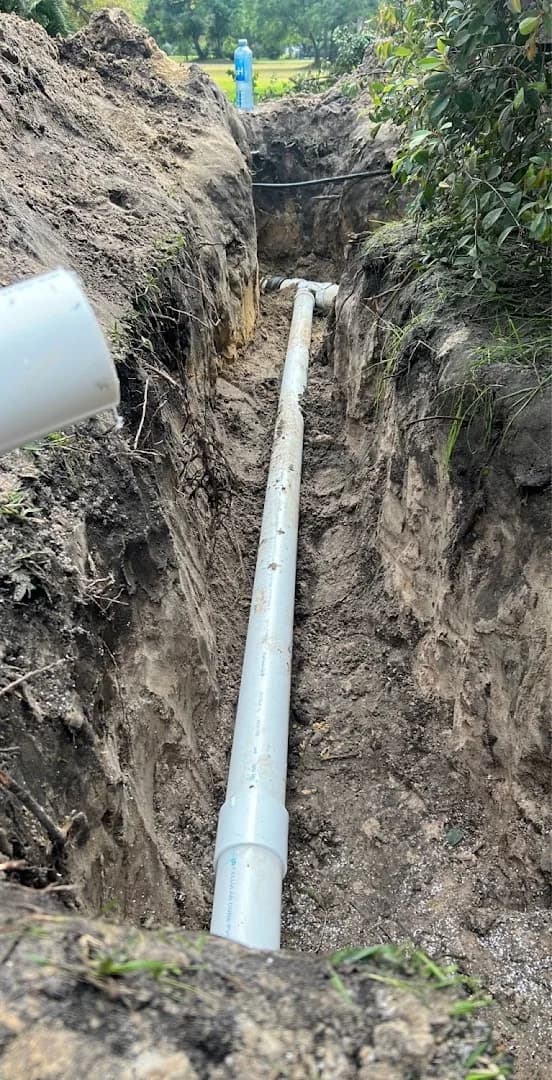 New PVC sewer line laid in a residential trench